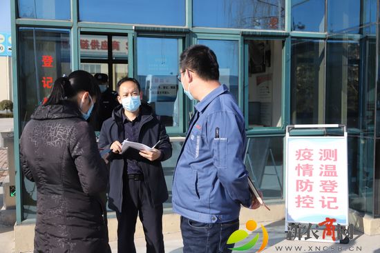西海岸新区医疗服务队的队员在向袁鹏介绍防疫工作注意事项和细节。（王培珂 摄）.jpg